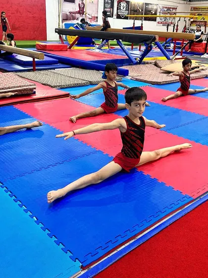 Look at the discipline and uniformity. A line of my young male gymnasts holding a perfect split, demonstrating the results of consistent flexibility training.