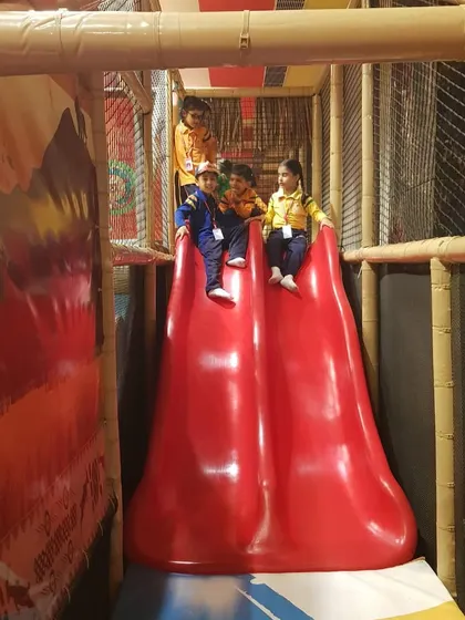 A train of friends heading down the big red slide. Our structures are perfect for group play, allowing kids to enjoy the fun together.