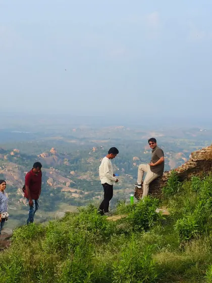 Chilling on the edge of a fort wall, taking in the green landscape below. My treks are full of such picturesque spots.