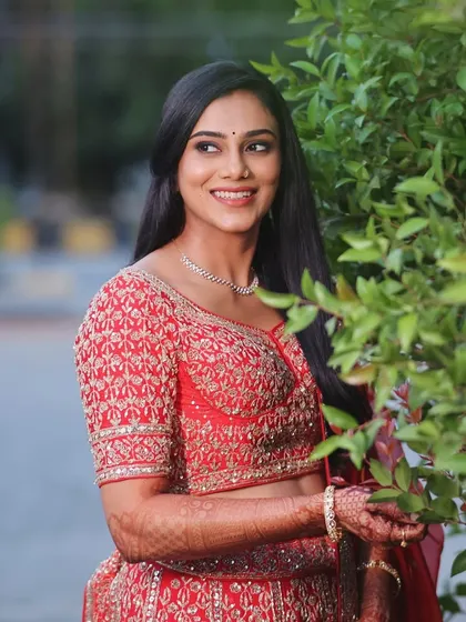 A candid moment from her reception photoshoot. The makeup looks fresh and beautiful in natural evening light.