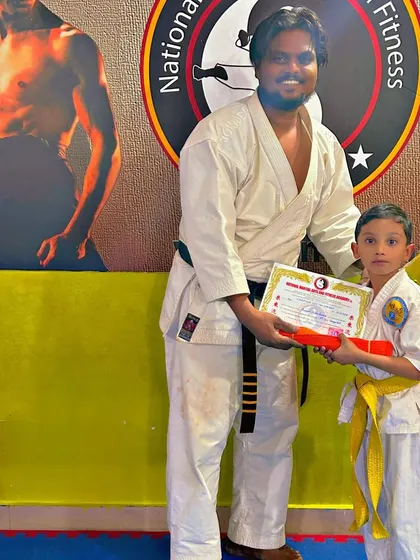 This student receives his yellow belt, the first major milestone in his Karate training.