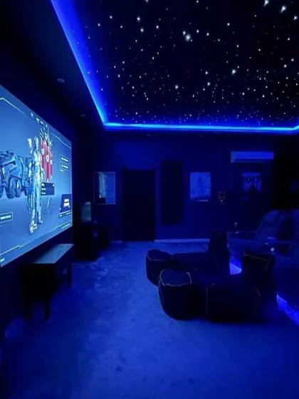 The same gaming room can transform its mood instantly with smart lighting control. Here, a cool blue theme is activated for a different game, showcasing how flexible and personalized your entertainment space can be.