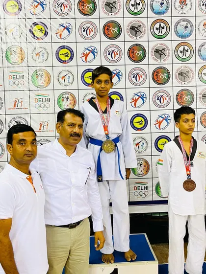 Bhanu Pratap standing tall on the podium with his gold medal from the 39th Delhi State Taekwondo Championship.