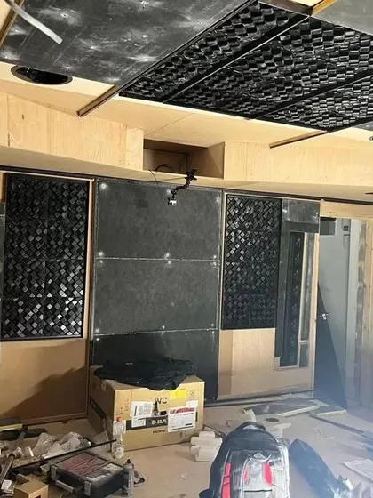 A work-in-progress shot showing the complex acoustic treatment behind the final fabric walls. You can see the diffusers and absorbers that are critical for perfect sound.