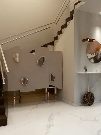 This entrance foyer for a Dubai client exudes contemporary flair with a unique console table featuring agate-like cutouts and a fluted wall panel.