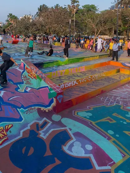 Skaters dropping into the bowl at the revitalized Bandra Skatepark. The art is made to be part of the action, not just a backdrop.
