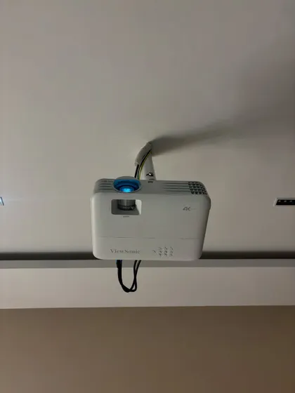 A clean ceiling installation of a ViewSonic 4K projector. My team ensures all wiring is concealed and the placement is perfect for the screen size and room dimensions, giving you a professional, hassle free setup.