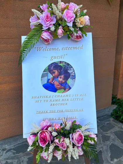 A simple and sweet custom name board for a baby naming ceremony, personalized with a photo.
