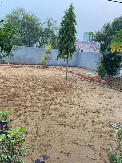 A bare patch of land at a farmhouse, just waiting to be turned into a beautiful lawn.