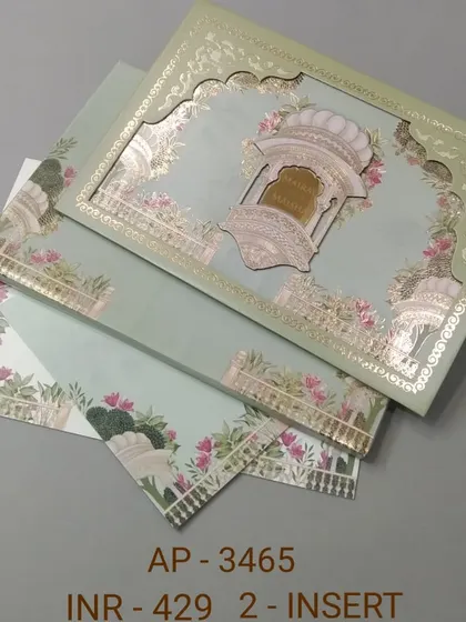 This pastel green invitation features a beautiful laser-cut arch with gold foil details. The matching inserts are adorned with floral and elephant motifs for a complete traditional look.