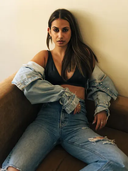 A relaxed, cool-girl pose on a couch with natural light. This shows a model's ability to look effortless and chic.