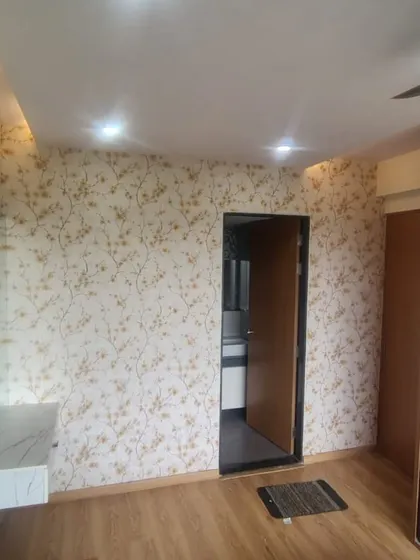 A delicate and sparse branch pattern wallpaper in a bedroom. This minimalist design adds a touch of nature and elegance, creating a serene and uncluttered look around the vanity area.