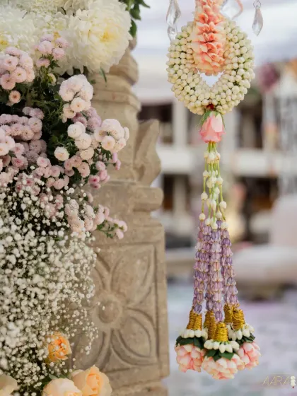 A close-up of the delicate floral details from a minimal and magical engagement setup. Hand-tied garlands of jasmine and roses add a touch of traditional craftsmanship to the modern design.