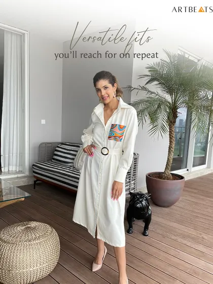 A versatile fit you'll reach for on repeat. The Moonrise Trench Dress, seen here styled in a modern home, is a perfect example of an elevated basic with an artistic twist.