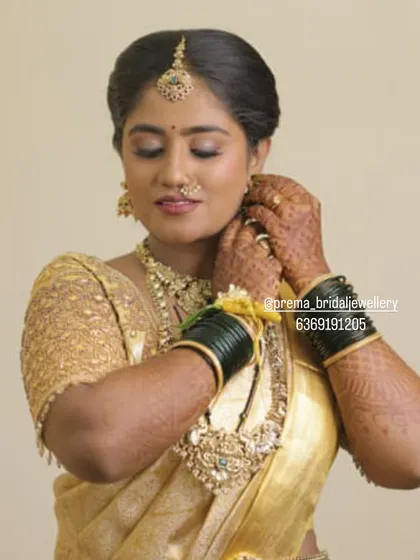 A close-up showing the intricate design of the earrings and the matching ring.