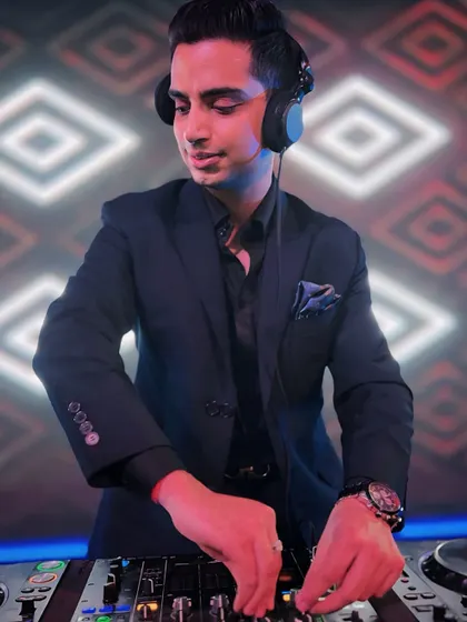 Focused and in the zone, mixing tracks against a dynamic LED backdrop. This is a glimpse of me at work, reading the crowd and crafting the perfect musical journey for the night.