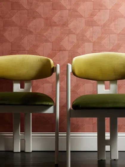A wall adorned in the 'Clay' wallcovering by Nobilis, which creates a captivating trompe l’oeil effect of glossy tiles. The matte, finely ridged texture provides a unique and unexpected finish.