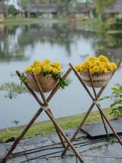 Baskets of fresh marigolds ready for a celebration, set against a serene lakeside backdrop.