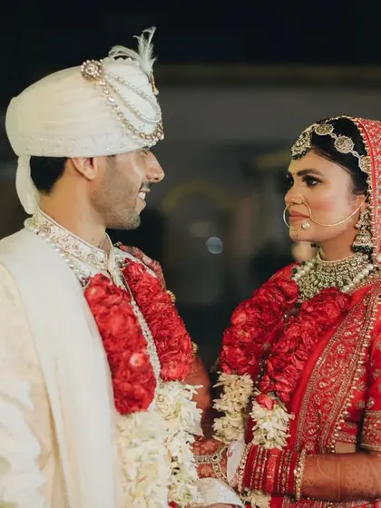A sweet, candid moment between the couple. The way they look at each other with genuine smiles captures the love and happiness of their wedding day.