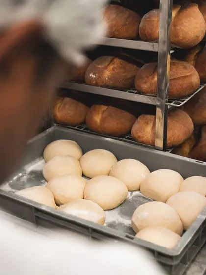 Racks of cooling sourdough bread. The aroma in our bakery at this time is absolutely incredible. We bake these fresh every single day.