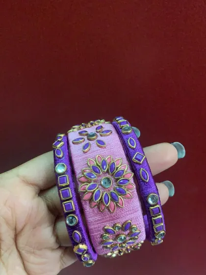 A beautiful set combining pink and purple silk thread, with intricate floral meenakari work. This shows how I can mix colours and designs for a custom set.