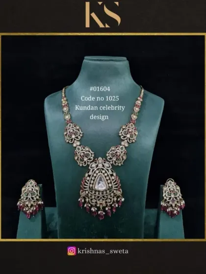 Our Kundan celebrity design set, featuring a statement necklace with a large uncut stone pendant and ruby accents. This piece is designed to make you feel like a star.