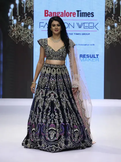 A full frontal view of the royal blue velvet lehenga from our runway show. The intricate handcrafting and the contrast of the dusky peach dupatta create a look of pure opulence.