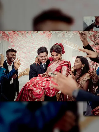 A candid shot of the celebration. The groom carries his bride, surrounded by the happy faces of their friends and family.