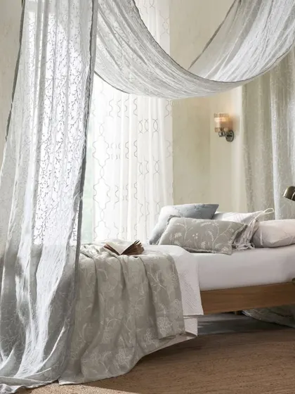 For this 'Sheers' collection, we used the fabric to create a soft, ethereal canopy. The setup demonstrates the product's versatility and adds a touch of romance and dreaminess to the bedroom interior.