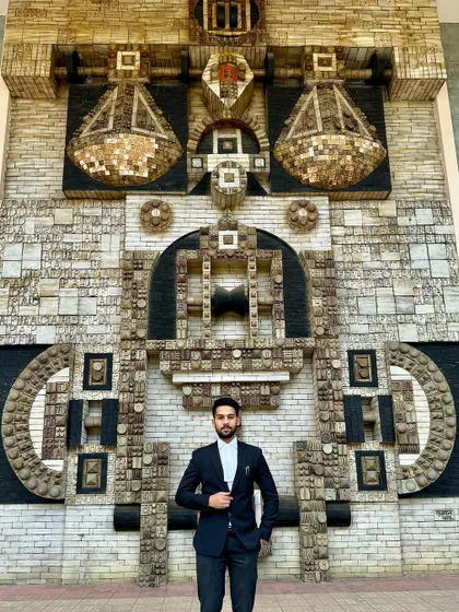 Standing before an art installation that evokes the scales of justice. For me, justice is the conscience of humanity, and my work is a constant effort to heed its voice.
