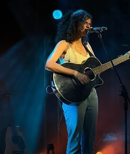 A full-length shot of me on stage. This gives you an idea of my stage presence during a solo acoustic set at a large concert.