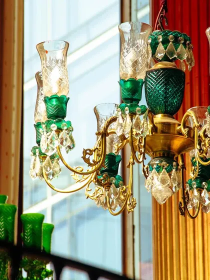Our stunning green and gold chandeliers blend luxury and charm effortlessly, turning every occasion into a radiant affair.