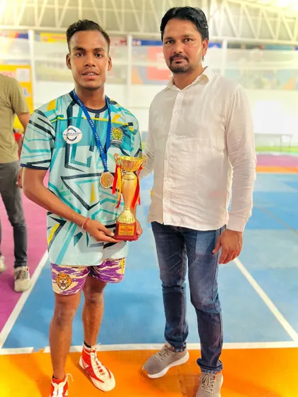 One of our standout players with the coach, holding the 2nd place trophy from the C.B.S.E. Nationals.