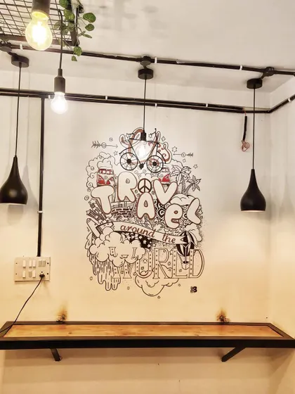 This travel themed doodle for Cafe Graffiters in Koramangala fits perfectly in this cozy corner. It's a great example of how our marker art can fill a small space with personality.