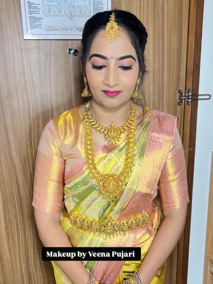 A soft and pretty look for Soujanya for her brother-in-law's engagement. The pastel saree and gold jewelry are a classic combination.