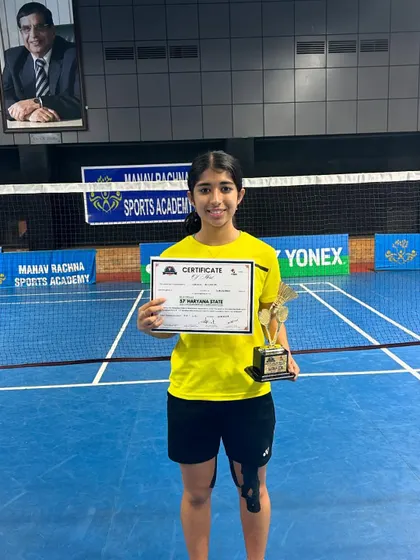 Nandini Acharya with her certificate and gold medal trophy after winning the U13 girls' doubles at the Haryana State Championship 2024 in Faridabad.