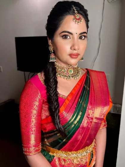 The complete look is both traditional and fresh. The intricate braid and classic makeup create a stunning bridal profile.
