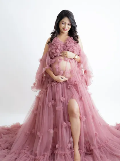 A beautiful portrait in a dusty pink gown with floral appliqué. The soft, romantic feel of the dress is perfect for a dreamy maternity shoot.