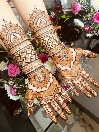 Another angle of this intricate bridal design, showing how the patterns flow seamlessly from the palm to the wrist and forearm.