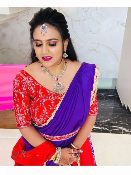 A beautiful candid of Poorva, highlighting her makeup and the detailed neckline of her custom-embroidered red blouse.