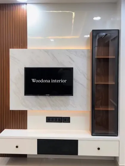 This full view shows the complete TV unit with its floating console, which includes both closed cabinets and an open display niche. The design provides ample storage while maintaining a clean look.