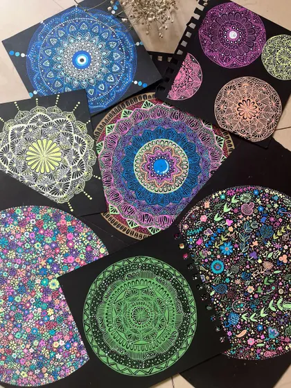 A flat lay of several of my favorite mandala pieces on black paper.