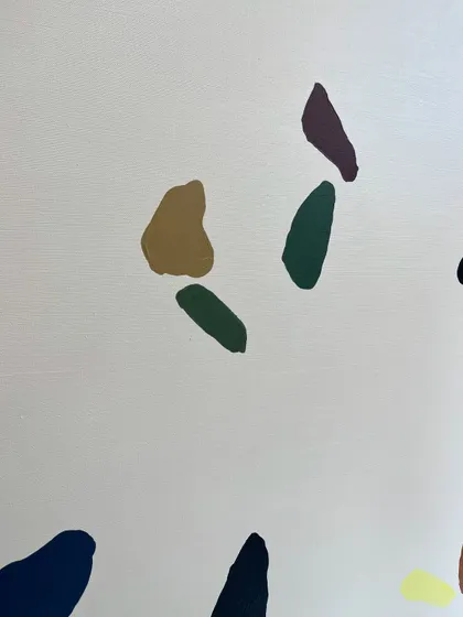 A close-up of the colorful abstract shapes. Each one is carefully painted to look like a natural stone fragment found in terrazzo flooring.
