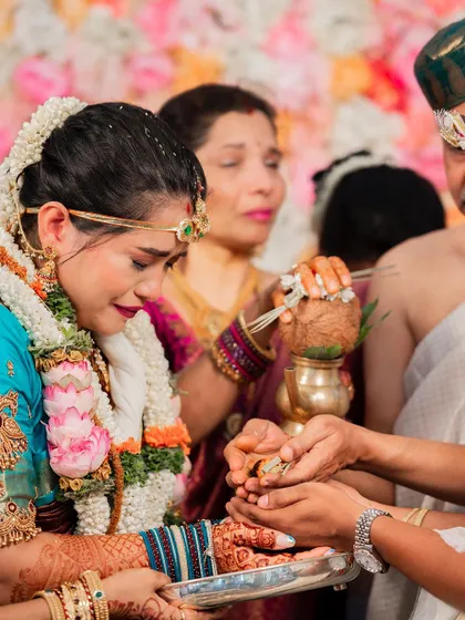 A close-up of the bride during an emotional ritual. Her makeup remains impeccable, a testament to the quality of products and techniques used.