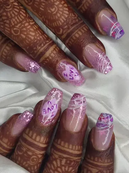 A closer look at the details on this custom bridal set. The combination of glitter, hand-lettering, and abstract designs makes for a truly personal and memorable manicure for the big day.