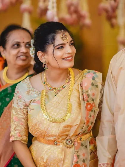 A beautiful makeover for the new mom, Pooja, at her child's naming ceremony. The look is minimal and fresh, perfect for a daytime family event.