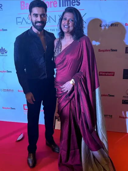 On the red carpet with a friend. He looks sharp in this all-black look. I am now designing modern and traditional wear for men for all occasions.