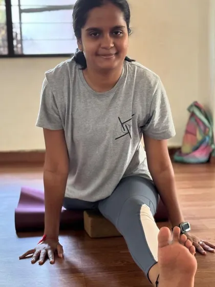 A focused moment in Prerana's split practice. We emphasize mindful movement and using props like blocks and mats to support the body as it opens.