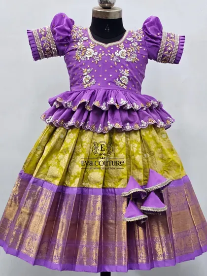 A detailed shot of the purple and lime green lehenga. The puff sleeves also feature matching embroidery, coordinating perfectly with the blouse.