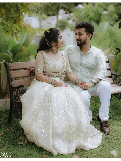 A loving gaze shared between a couple on a park bench, surrounded by greenery, perfect for a save-the-date photo.